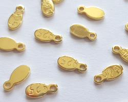  vermeil, stamped 925, 6.25mm x 3mm x 0.8mm oval tag with integral 0.7mm hole [vermeil is gold plated sterling silver] 