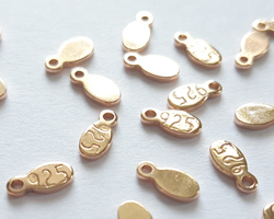  ROSE VERMEIL, stamped 925, 6.25mm x 3mm x 0.8mm oval tag with integral 0.7mm hole [vermeil is gold plated sterling silver] 