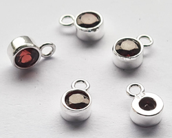  ** NEW LOWER PRICE ** sterling silver, stamped 925, 8.35mm x 5.15mm drop / charm containing a 4mm garnet cubic zironia, very nicely made, has closed jumpring attached at the top with internal diameter of 1.5mm 